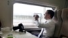 CHINA -- Russia's President Dmitry Medvedev takes pictures as he travels by high-speed train from Sanya to Boao to take part in the 10th Boao Forum for Asian Annual Conference, April 15, 2011. 