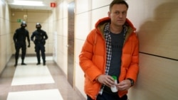 RUSSIA -- Russian opposition leader Aleksei Navalny stands near law enforcement agents in a hallway of a business centre, which houses the office of his Anti-Corruption Foundation (FBK), in Moscow, December 26, 2019