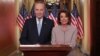 U.S. -- U.S. Speaker of the House Nancy Pelosi and Senate Minority Leader Chuck Schumer pose for photographers after concluding their joint response, to President Trump's prime time address, on Capitol Hill in Washington, U.S., January 8, 2019